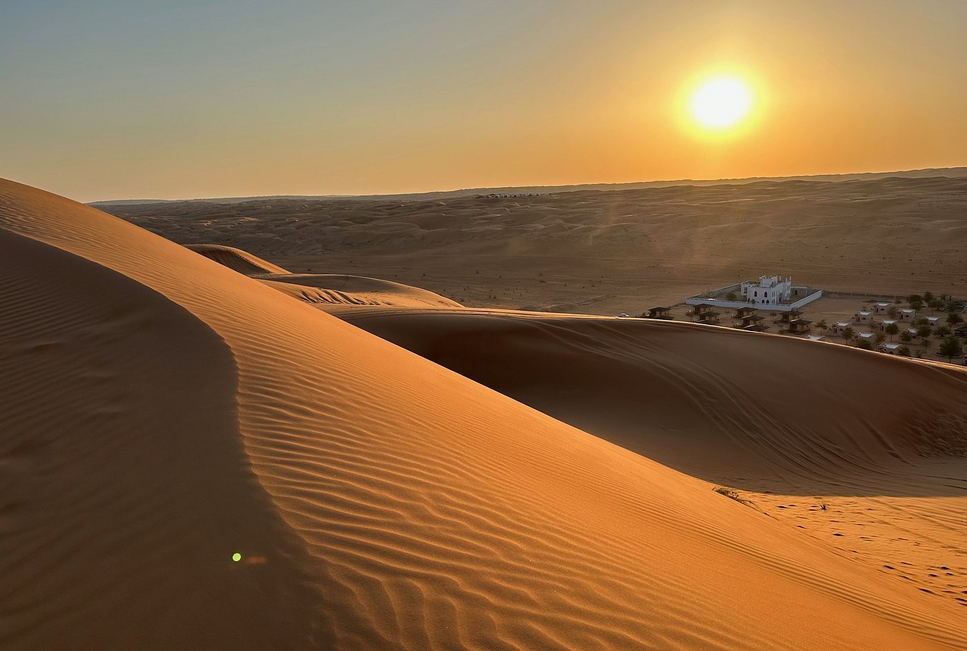 Sunset over Wahiba Sands desert dunes