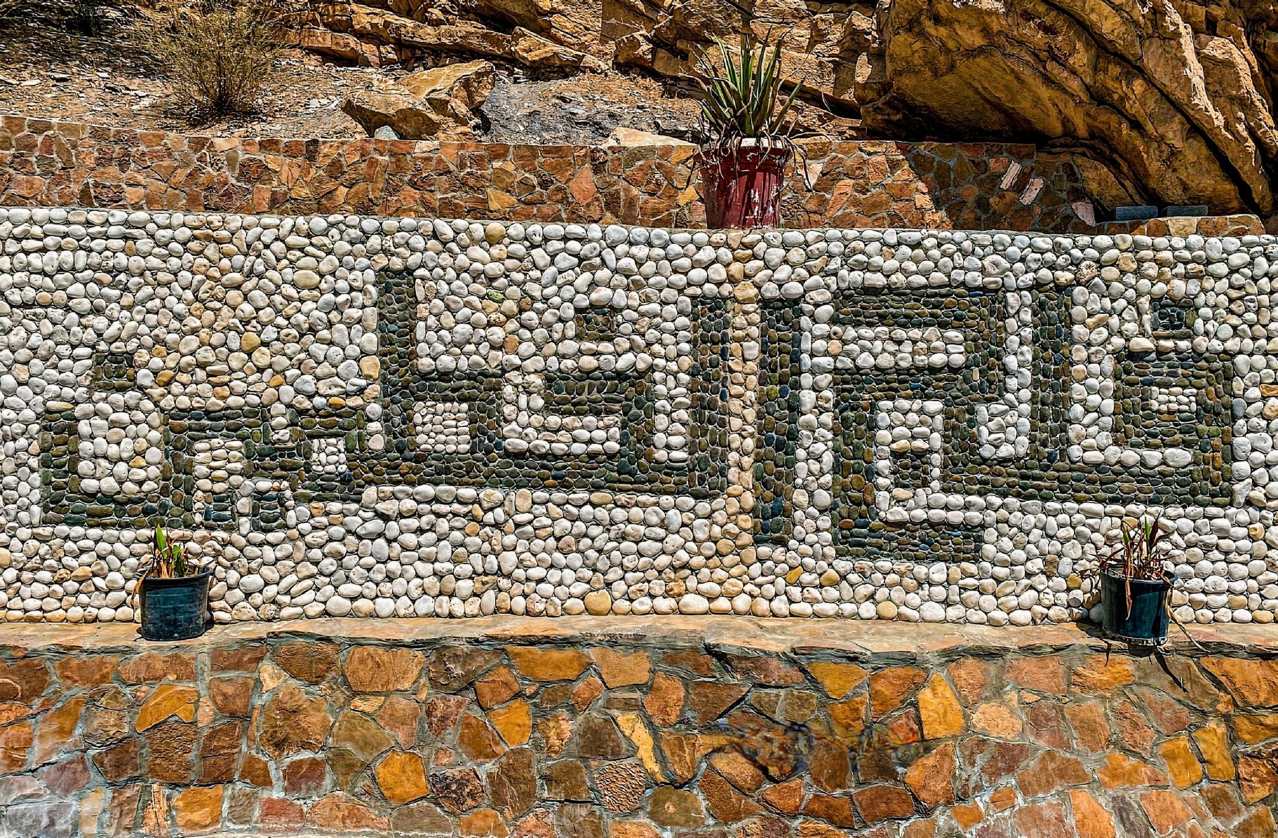 Aerial view of the Al-Kattmyn Irrigation System in Oman, an impressive network of canals nurturing lush green vegetation. The system's engineering marvel sustains the region's agriculture, reflecting Oman's rich heritage and advanced irrigation techniques.