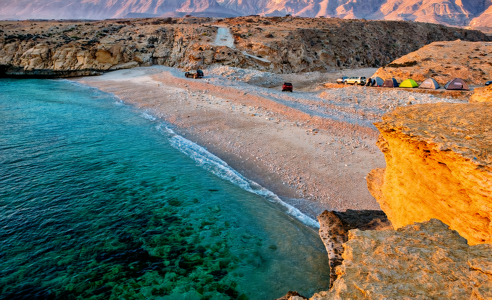 Relaxing ambiance of Fins Beach, where golden sands meet the gentle waves of the turquoise sea, creating a perfect coastal retreat.