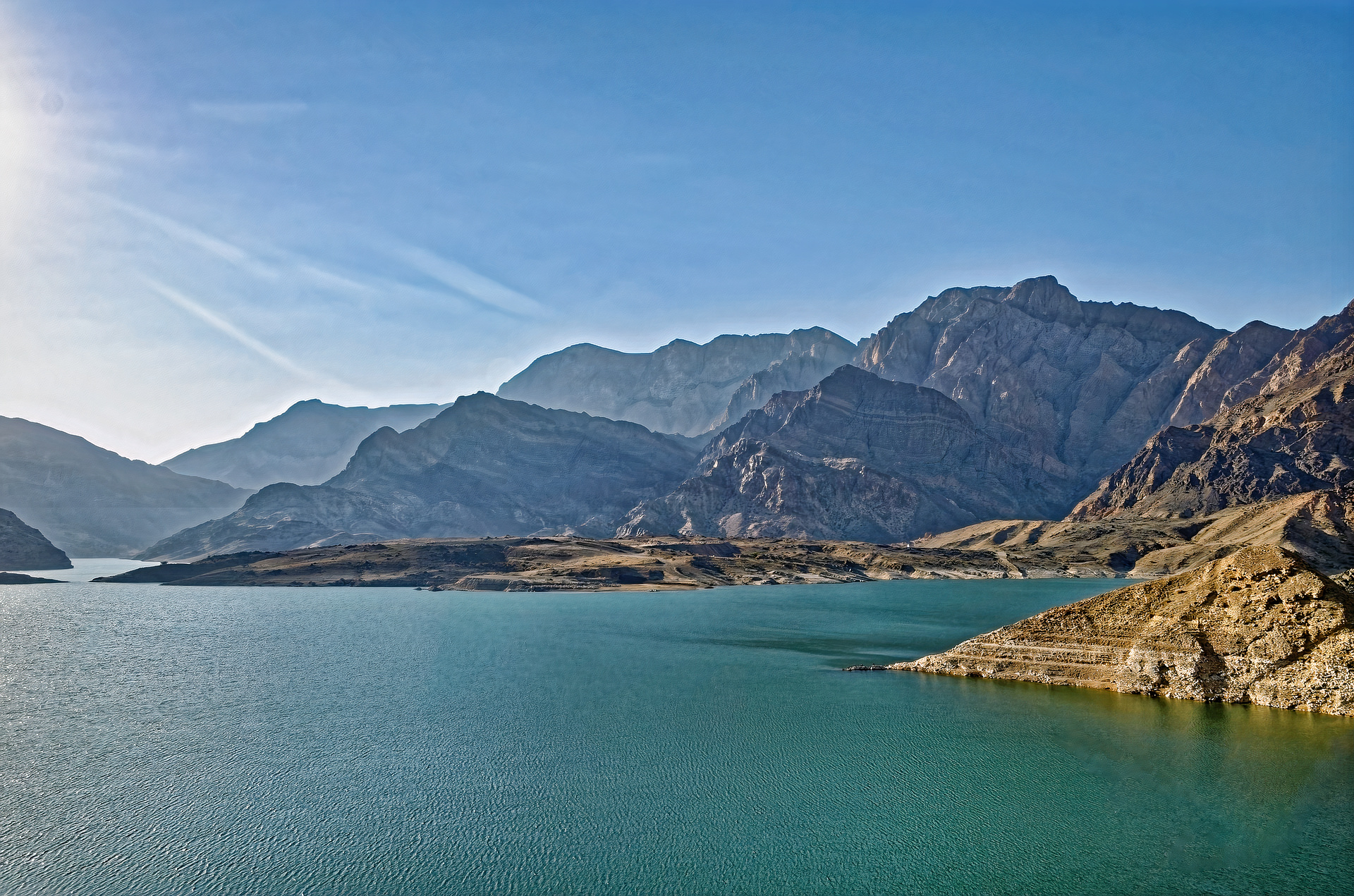 Breathtaking image of Wadi Dayqah Dam in Oman, displaying the magnificent blend of turquoise waters and stark mountainous landscape.